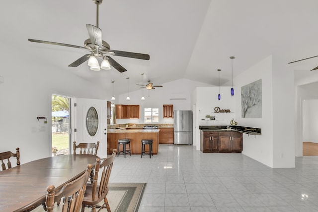 dining room featuring ceiling fan and high vaulted ceiling