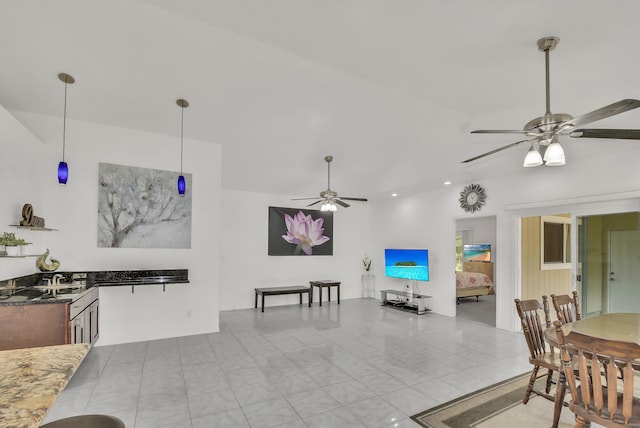 dining room featuring light tile patterned flooring, sink, and ceiling fan