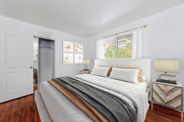 bedroom with dark wood-type flooring and a closet