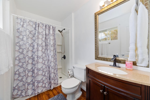 bathroom featuring hardwood / wood-style flooring, vanity, a shower with curtain, and toilet