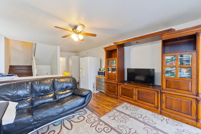 living room featuring ceiling fan and light hardwood / wood-style floors