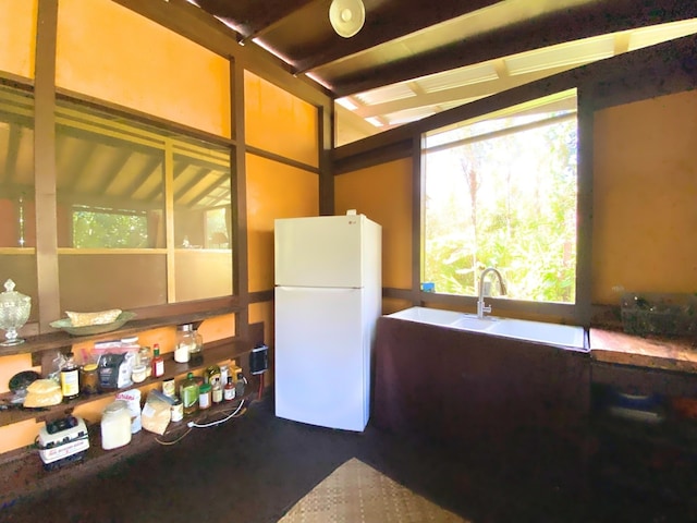 kitchen with sink and white fridge