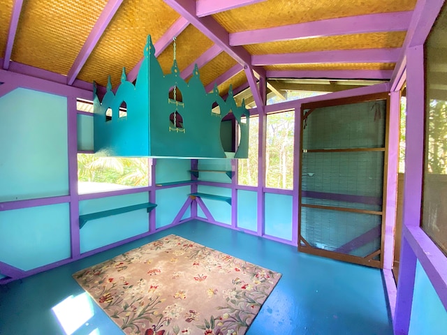 unfurnished sunroom with lofted ceiling with beams