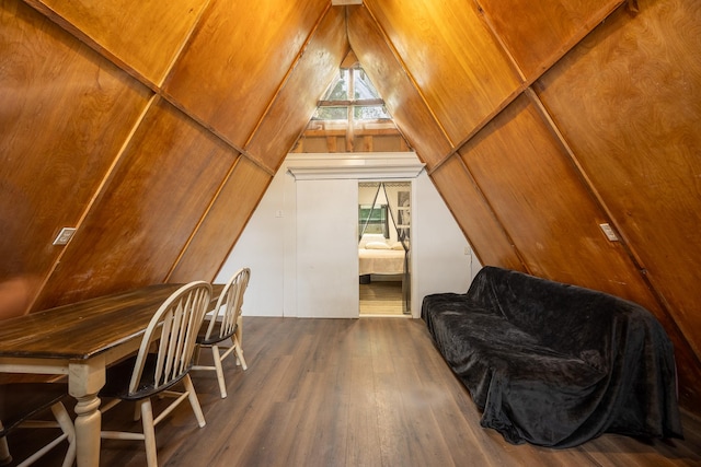 additional living space with dark hardwood / wood-style flooring and vaulted ceiling