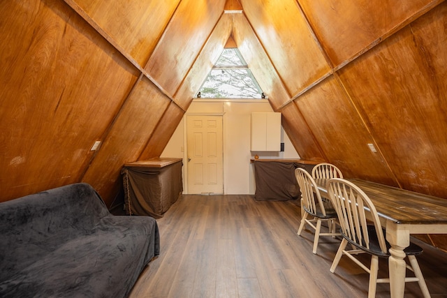 additional living space with lofted ceiling and wood-type flooring