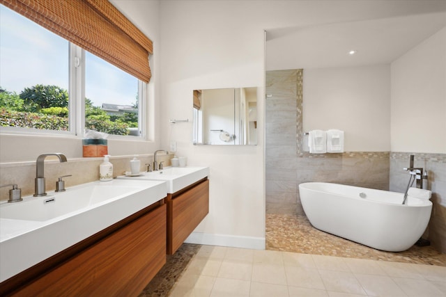 bathroom featuring vanity, separate shower and tub, tile patterned flooring, and tile walls