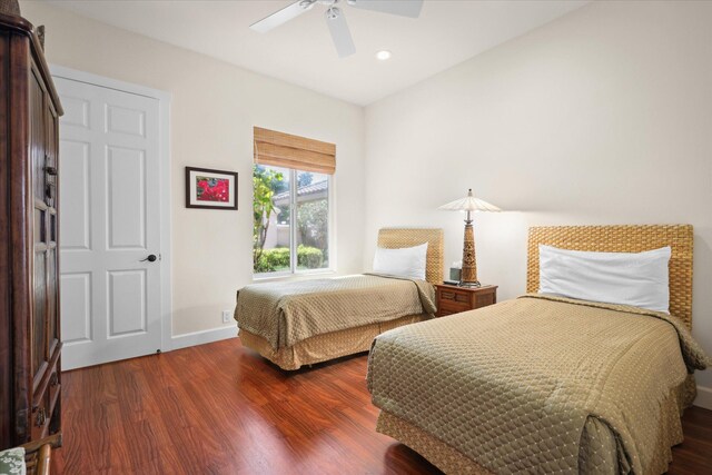 bedroom with dark hardwood / wood-style floors and ceiling fan