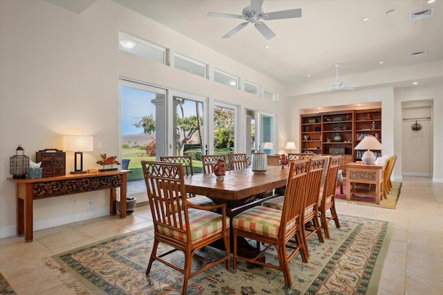 tiled dining room with built in shelves and ceiling fan