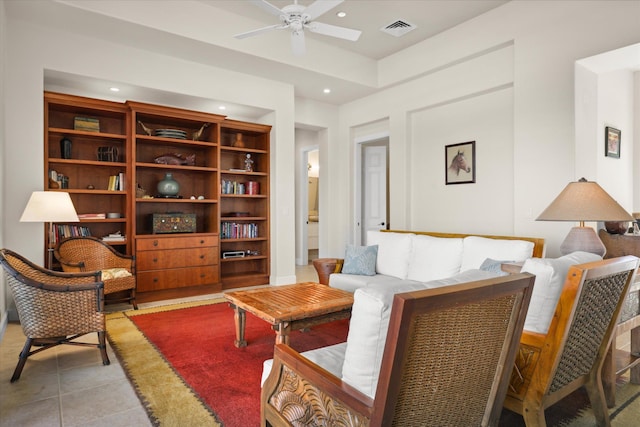 living room with ceiling fan and light tile patterned floors