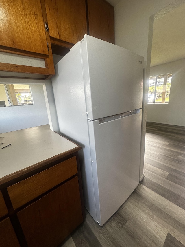 kitchen with light hardwood / wood-style floors and white refrigerator