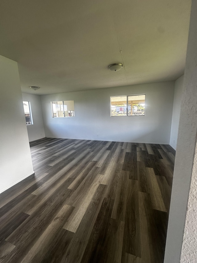 unfurnished room featuring dark wood-type flooring