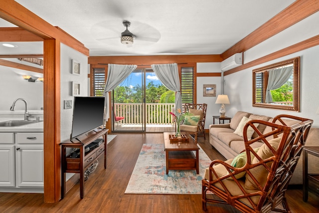 living room featuring dark hardwood / wood-style flooring, sink, a wall unit AC, and ceiling fan