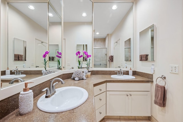 bathroom featuring an enclosed shower, vanity, and tile patterned floors