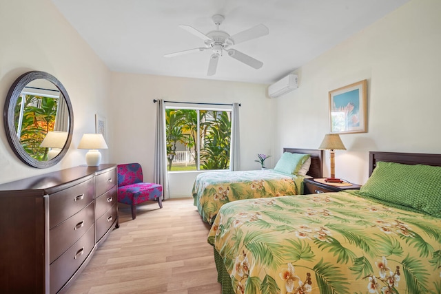 bedroom with ceiling fan, light wood-type flooring, and a wall unit AC