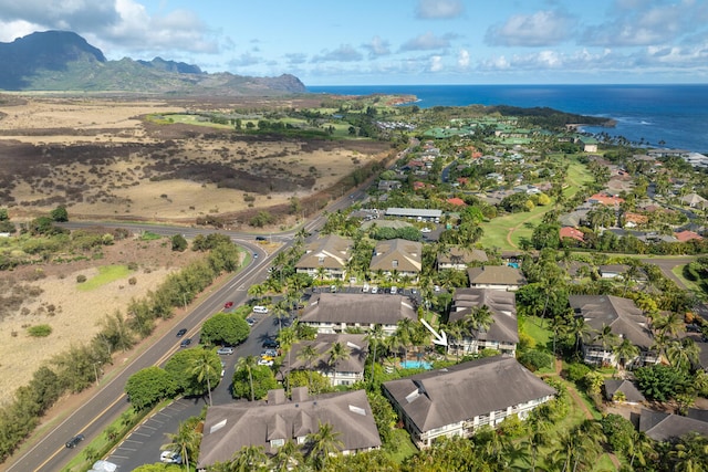 birds eye view of property with a water and mountain view