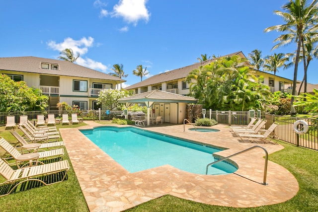 view of swimming pool featuring a community hot tub and a patio area