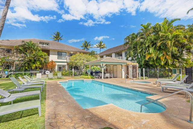 view of swimming pool featuring a gazebo, a community hot tub, and a patio