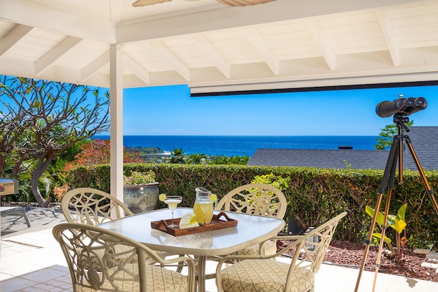 view of patio / terrace with ceiling fan and a water view