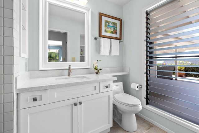 bathroom with vanity, tile patterned floors, and toilet