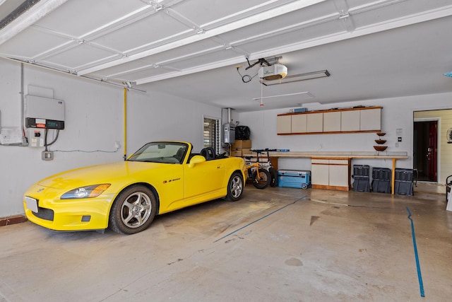 garage featuring a garage door opener and water heater