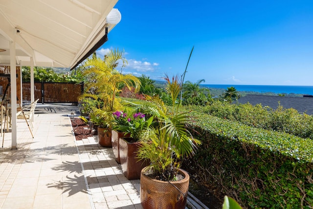 view of patio with a water view