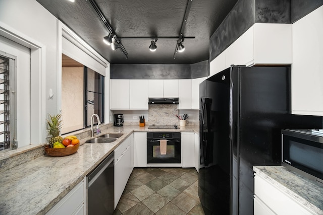 kitchen featuring white cabinetry, sink, decorative backsplash, black appliances, and light stone countertops