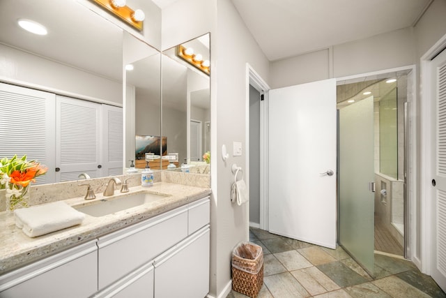 bathroom with vanity and a shower with shower door