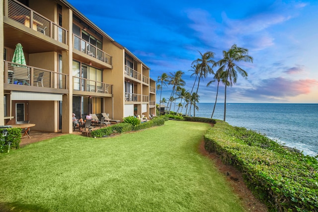 surrounding community featuring a yard and a water view