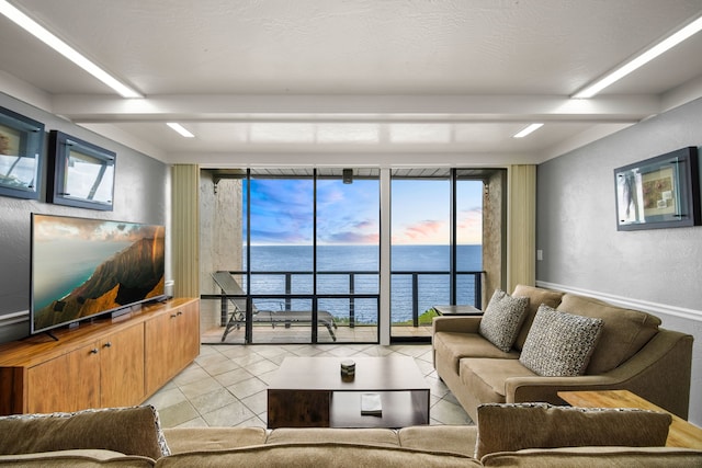 tiled living room featuring a water view