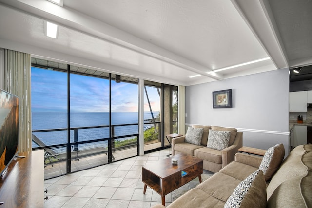 tiled living room with beam ceiling, floor to ceiling windows, and a water view