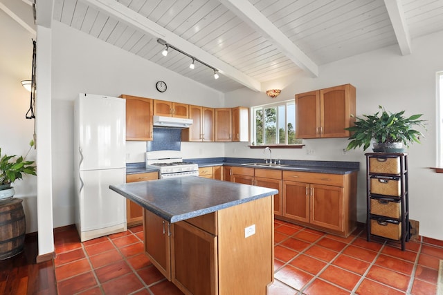 kitchen featuring rail lighting, sink, lofted ceiling with beams, a kitchen island, and white appliances