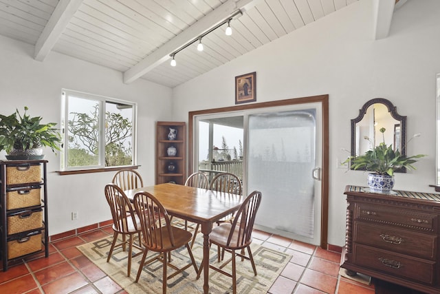 tiled dining area featuring lofted ceiling with beams, rail lighting, and wood ceiling