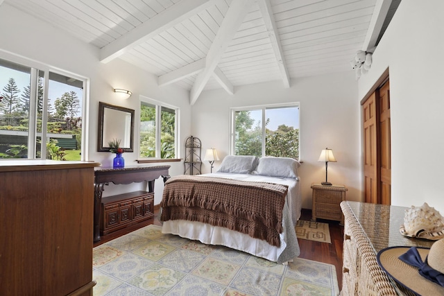 bedroom featuring beam ceiling, a closet, and light wood-type flooring