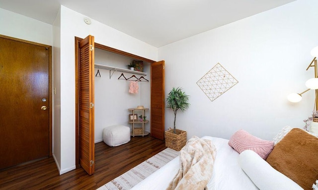 bedroom featuring dark hardwood / wood-style flooring and a closet