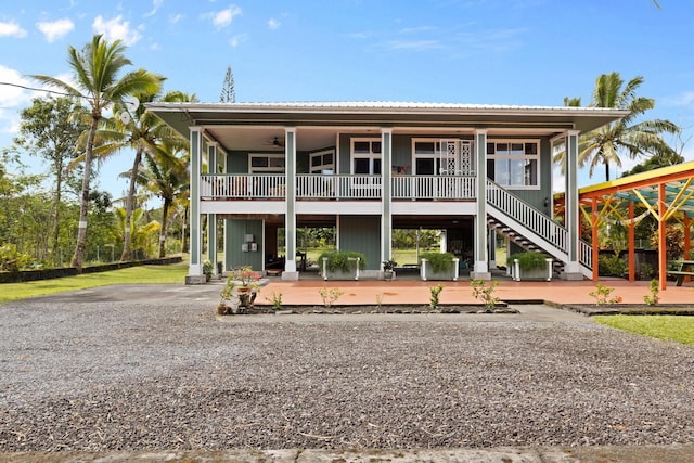 view of front of house featuring ceiling fan and a patio