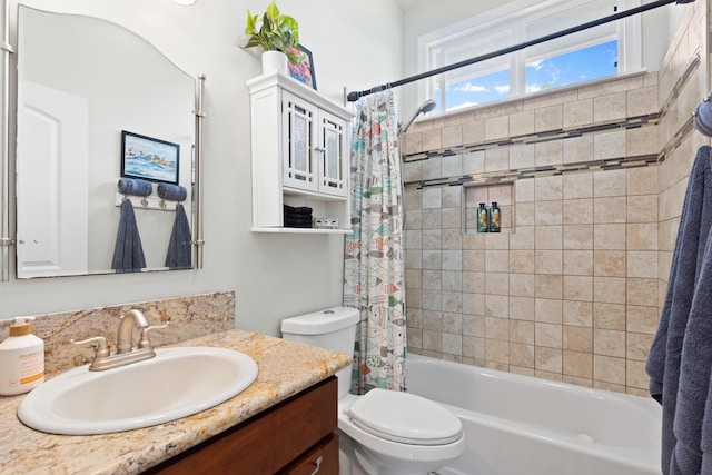 full bathroom featuring shower / tub combo with curtain, vanity, and toilet