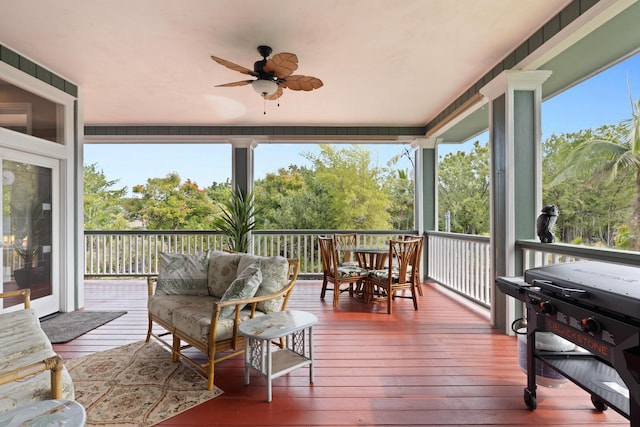 sunroom / solarium featuring a wealth of natural light and ceiling fan