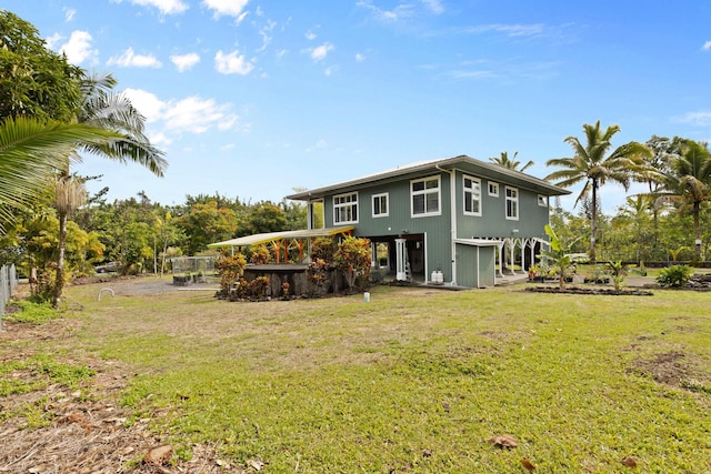 rear view of property with a yard