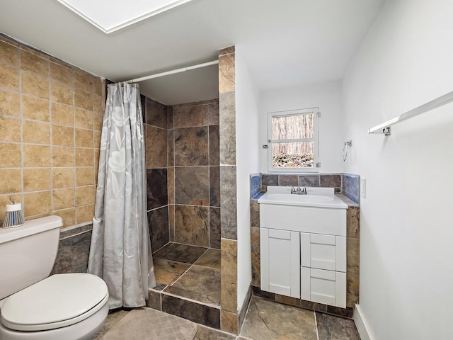 bathroom featuring tile walls, sink, toilet, and walk in shower