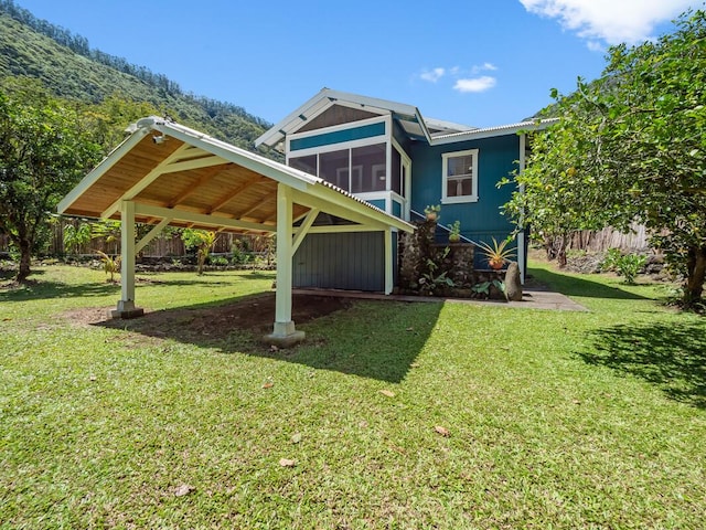 exterior space featuring a lawn and a sunroom