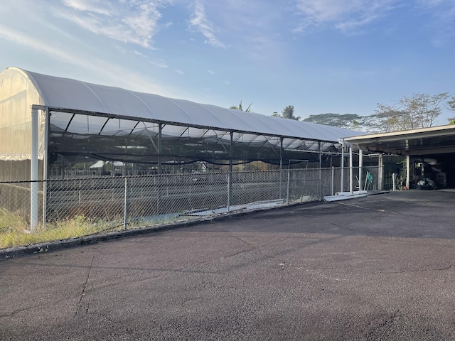 view of vehicle parking with a carport