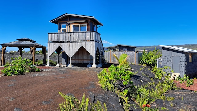 view of front facade featuring a gazebo and a shed