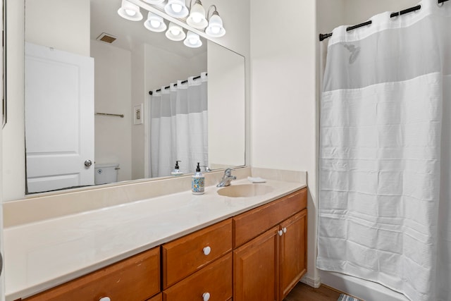 bathroom featuring vanity and a shower with shower curtain