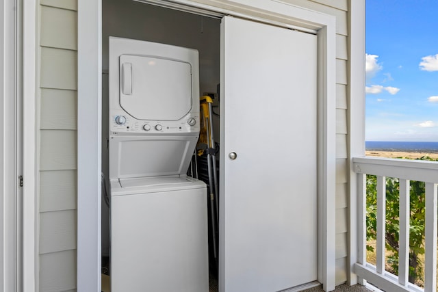 washroom featuring stacked washer / dryer