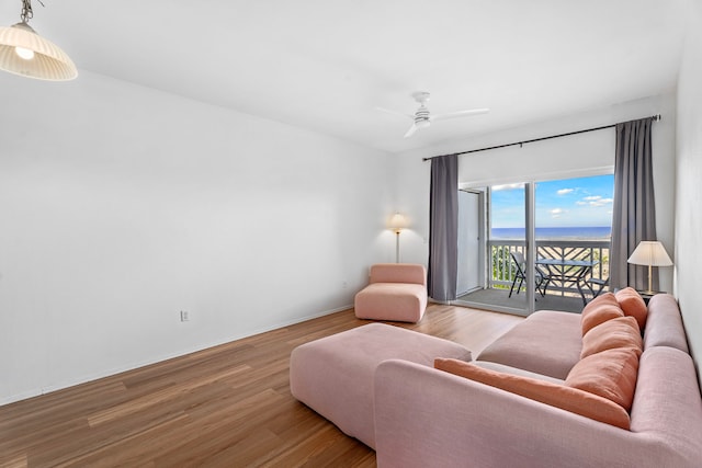 living room with ceiling fan and light hardwood / wood-style flooring