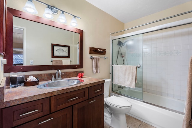 full bathroom with enclosed tub / shower combo, toilet, tile patterned floors, and vanity