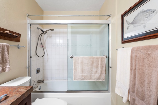 full bathroom featuring toilet, vanity, and bath / shower combo with glass door