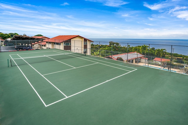 view of sport court with a water view