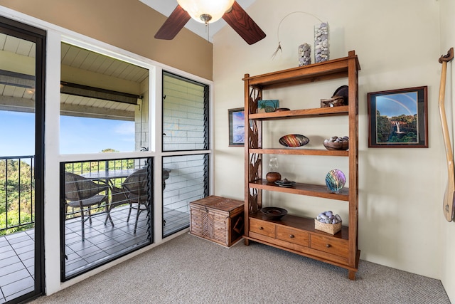 interior space featuring light colored carpet and ceiling fan