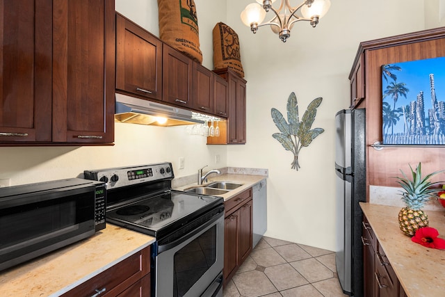 kitchen featuring light tile patterned flooring, appliances with stainless steel finishes, sink, a chandelier, and hanging light fixtures